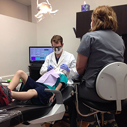 Dentist Tulsa - Dr. Howarth working with a patient
